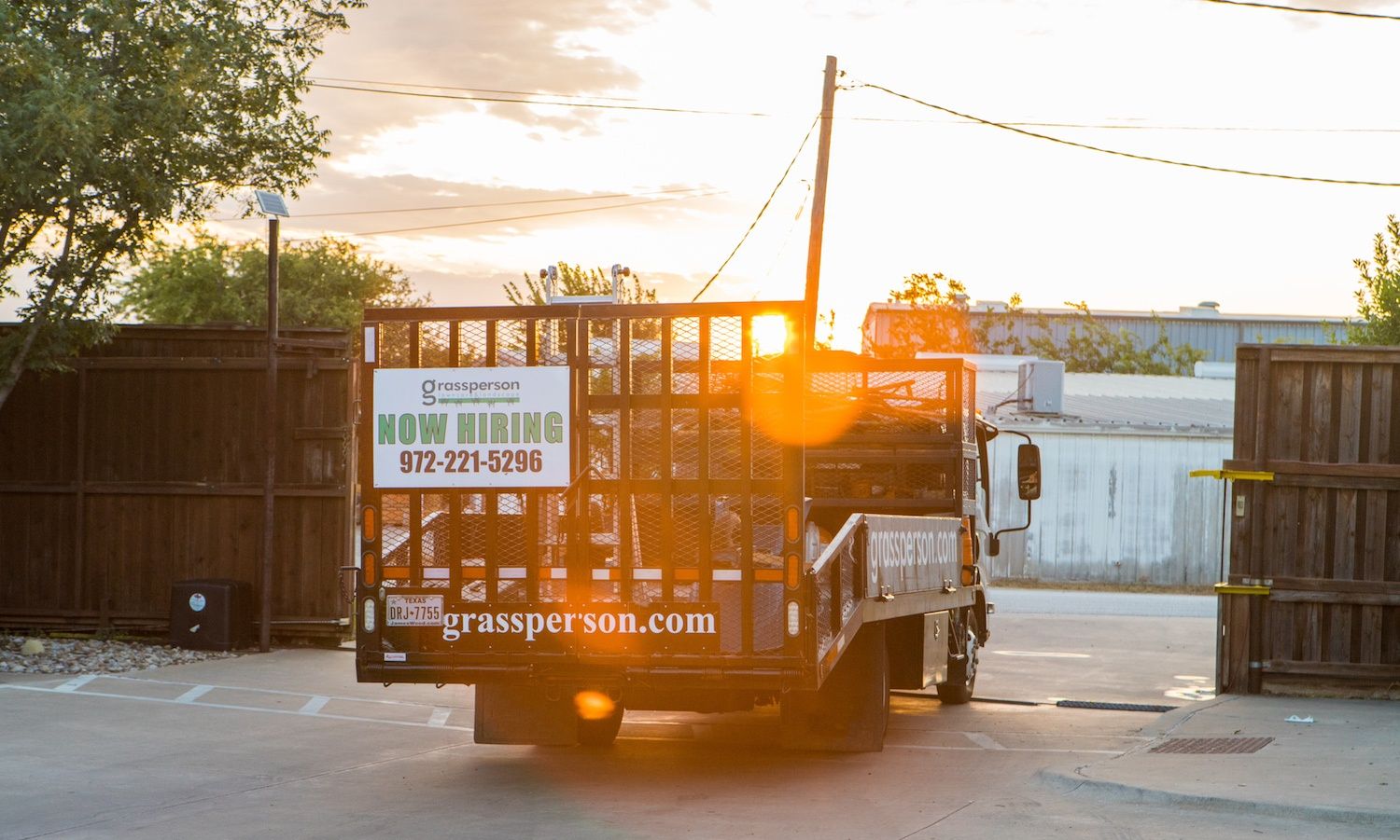 Grassperson truck with Now Hiring sign in Lewisville, TX
